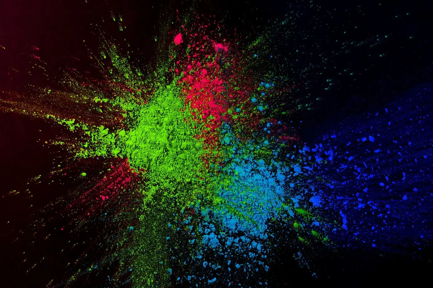 Очень яркая порошковая краска, разбрызганная на тёмном фоне.